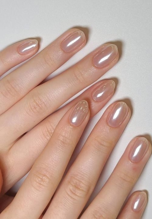 Trendy close-up nail art featuring glossy shine, chrome effects, and pastel tones.. This stylish nail design captures hottest beauty trends—clean, polished, and creatively de